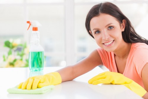 Cleaner wearing protective gloves while preparing safe cleaning supplies