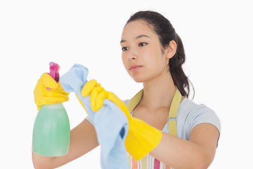 Cleaning supplies and tidy room representing Bromley cleaning services